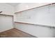 Spacious walk-in closet with hanging rods and shelving for ample storage at 19245 W Pasadena Ave, Litchfield Park, AZ 85340