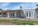 Rear view of house with a covered patio, stucco walls and a well-maintained lawn at 2119 N Recker Rd, Mesa, AZ 85215