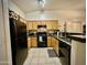 Traditional kitchen featuring wood cabinets, granite countertops, and modern appliances, ready for culinary adventures at 2150 E Bell Rd # 1113, Phoenix, AZ 85022