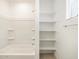 Bright bathroom with tub/shower combo and adjacent shelving at 24467 W Grenadine Rd, Buckeye, AZ 85326