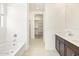 Bright bathroom showcasing a soaking tub, shower, double sink vanity, and walk-in closet at 24467 W Grenadine Rd, Buckeye, AZ 85326