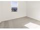 Sunlit bedroom with plush carpeting and a bright window at 24467 W Grenadine Rd, Buckeye, AZ 85326