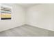 Neutral carpeted bedroom with a window and base trim at 24467 W Grenadine Rd, Buckeye, AZ 85326