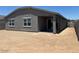Back exterior of home features a covered patio and spacious yard ready to customize at 24467 W Grenadine Rd, Buckeye, AZ 85326