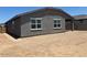The back exterior of the home with a spacious yard at 24467 W Grenadine Rd, Buckeye, AZ 85326