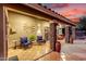 Covered back patio features rustic wood and stone elements, elegant furniture, and direct backyard access at 28802 N 45Th St, Cave Creek, AZ 85331