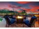 A backyard entertaining space featuring a fire pit, comfortable lounge seating, and lush desert landscaping at 28802 N 45Th St, Cave Creek, AZ 85331