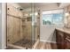 The primary bathroom features a luxurious walk-in shower with bench, niche, and floor-to-ceiling glass door at 28802 N 45Th St, Cave Creek, AZ 85331