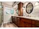 A primary bathroom offers dual sinks with granite counters and custom cabinets, plus a large window for natural light at 28802 N 45Th St, Cave Creek, AZ 85331