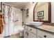 Small bathroom with a decorative shower curtain, decorative mirror, and vessel sink on white vanity at 28802 N 45Th St, Cave Creek, AZ 85331
