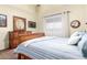 Cozy bedroom with warm wooden furniture, plush bedding, soft natural light, and complementary decor pieces at 28802 N 45Th St, Cave Creek, AZ 85331