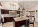 Modern kitchen featuring a kitchen island, stainless steel appliances, dark cabinetry, and stylish pendant lighting at 28802 N 45Th St, Cave Creek, AZ 85331