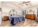 Cozy primary bedroom boasting modern ceiling fan, wood-look flooring, and ample natural light for relaxation at 28802 N 45Th St, Cave Creek, AZ 85331