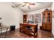 Bright office with hardwood floors, desk, ceiling fan, natural light from window, and antique decorative pieces at 28802 N 45Th St, Cave Creek, AZ 85331