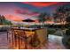 Outdoor kitchen with bar seating and built-in grill provides an ideal space for entertaining outdoors at 28802 N 45Th St, Cave Creek, AZ 85331