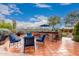 Expansive outdoor living area with bar seating, a BBQ, and comfortable seating under a large umbrella at 28802 N 45Th St, Cave Creek, AZ 85331