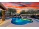 Inviting pool with stone pillar, water feature, desert landscaping and lighting that is perfect for backyard relaxation at 28802 N 45Th St, Cave Creek, AZ 85331
