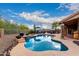 Beautiful backyard featuring a sparkling pool, rock accents, and a cozy outdoor dining and lounging area at 28802 N 45Th St, Cave Creek, AZ 85331
