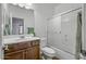 Bathroom with dark cabinets, tiled floors, glass shower, and a toilet at 301 S 225Th Ave, Buckeye, AZ 85326