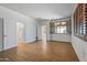 Spacious bedroom featuring wood-look floors, two closets, and an open window at 301 S 225Th Ave, Buckeye, AZ 85326