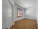 An empty bedroom with wood look floors, shutters, and a double door closet at 301 S 225Th Ave, Buckeye, AZ 85326