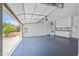 Open garage with epoxy flooring, storage cabinets, and exterior access at 301 S 225Th Ave, Buckeye, AZ 85326