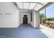 Garage interior with epoxy flooring and an open door that allows natural light and outdoor views at 301 S 225Th Ave, Buckeye, AZ 85326