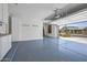 A spacious garage with custom storage and blue epoxy floors at 301 S 225Th Ave, Buckeye, AZ 85326