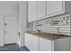 Garage utility sink with wooden countertop, custom storage, and neutral paint at 301 S 225Th Ave, Buckeye, AZ 85326