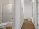 Hallway leading to the bathroom with a shower and the front door at 301 S 225Th Ave, Buckeye, AZ 85326