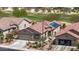 Aerial shot of single-story home showcasing a tile roof, solar panels, desert landscaping, and a two car garage at 301 S 225Th Ave, Buckeye, AZ 85326