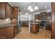 Spacious kitchen featuring wooden cabinets, stainless steel appliances, and a granite-topped island at 301 S 225Th Ave, Buckeye, AZ 85326