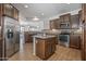 Bright kitchen featuring granite countertops, stainless steel appliances, and ample storage at 301 S 225Th Ave, Buckeye, AZ 85326
