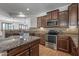 Well-designed kitchen with a central island, granite counters, and stainless appliances at 301 S 225Th Ave, Buckeye, AZ 85326