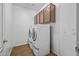 Laundry room featuring cabinets and newer appliances at 301 S 225Th Ave, Buckeye, AZ 85326