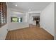 Open living area featuring wood floors, neutral walls, and view into adjoining rooms at 301 S 225Th Ave, Buckeye, AZ 85326