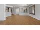 Spacious living room with wood-look floors, featuring an open layout and natural light at 301 S 225Th Ave, Buckeye, AZ 85326