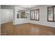 Bright and airy living room featuring wood floors, neutral walls, and stylish window shutters at 301 S 225Th Ave, Buckeye, AZ 85326