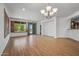 Open living area with wood-look flooring, large windows, and seamless access to the outdoors at 301 S 225Th Ave, Buckeye, AZ 85326