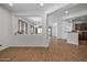 Spacious living area with wood-look floors, neutral walls, and view into adjoining rooms at 301 S 225Th Ave, Buckeye, AZ 85326