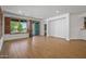Bright living room with wood-look flooring and sliding glass doors to outdoor area at 301 S 225Th Ave, Buckeye, AZ 85326