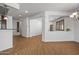 Open-concept living room with wood flooring, white walls, and view into adjoining rooms at 301 S 225Th Ave, Buckeye, AZ 85326