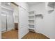 Bedroom walk-in closet featuring shelving and a sliding door at 301 S 225Th Ave, Buckeye, AZ 85326