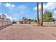 Expansive gravel backyard featuring the home's rear and surrounding block fence at 311 N Henkel --, Mesa, AZ 85201