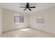 Well-lit bedroom with hardwood floors, a ceiling fan, and two large windows at 311 N Henkel --, Mesa, AZ 85201