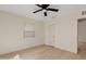 A well-lit bedroom with hardwood floors, a ceiling fan, and a window at 311 N Henkel --, Mesa, AZ 85201