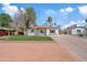 Charming single-story home with a well-maintained front yard, a long driveway, and a traditional design at 311 N Henkel --, Mesa, AZ 85201