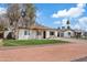 Single-story home with a neat lawn, desert landscaping, and a long driveway, showcasing its curb appeal at 311 N Henkel --, Mesa, AZ 85201