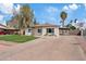 Inviting home with a well-kept lawn and a lengthy driveway, under a bright sky, offering comfortable living at 311 N Henkel --, Mesa, AZ 85201
