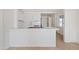 Modern kitchen with white cabinets, a breakfast bar, and stainless steel appliances, creating a clean and stylish space at 311 N Henkel --, Mesa, AZ 85201